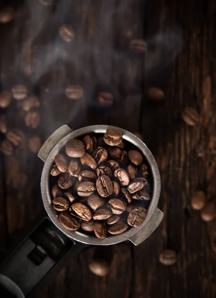 Fresh coffee beans in coffee maker.