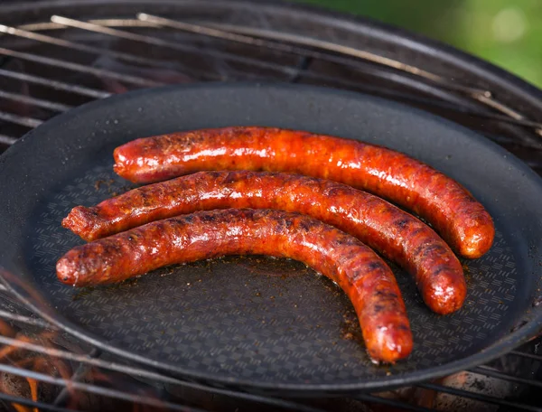 Barbecue grill with sausages in cast iron pan.p. — Stock Photo, Image