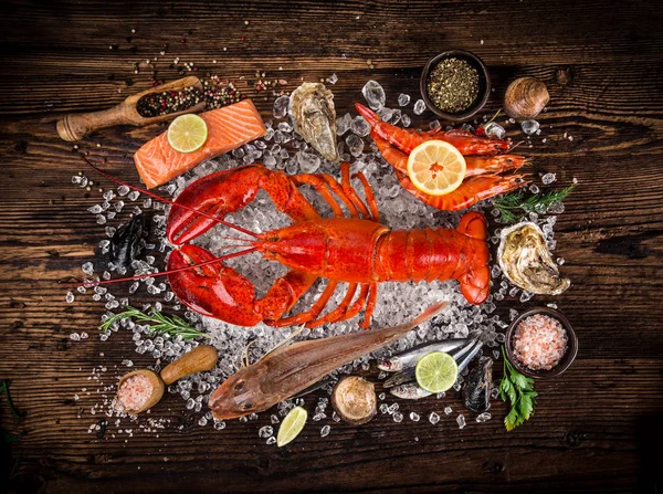 Fresh tasty seafood served on old wooden table. — Stock Photo, Image