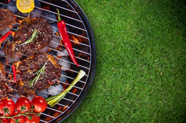 Barbecue grill with beef steaks, close-up. clipart