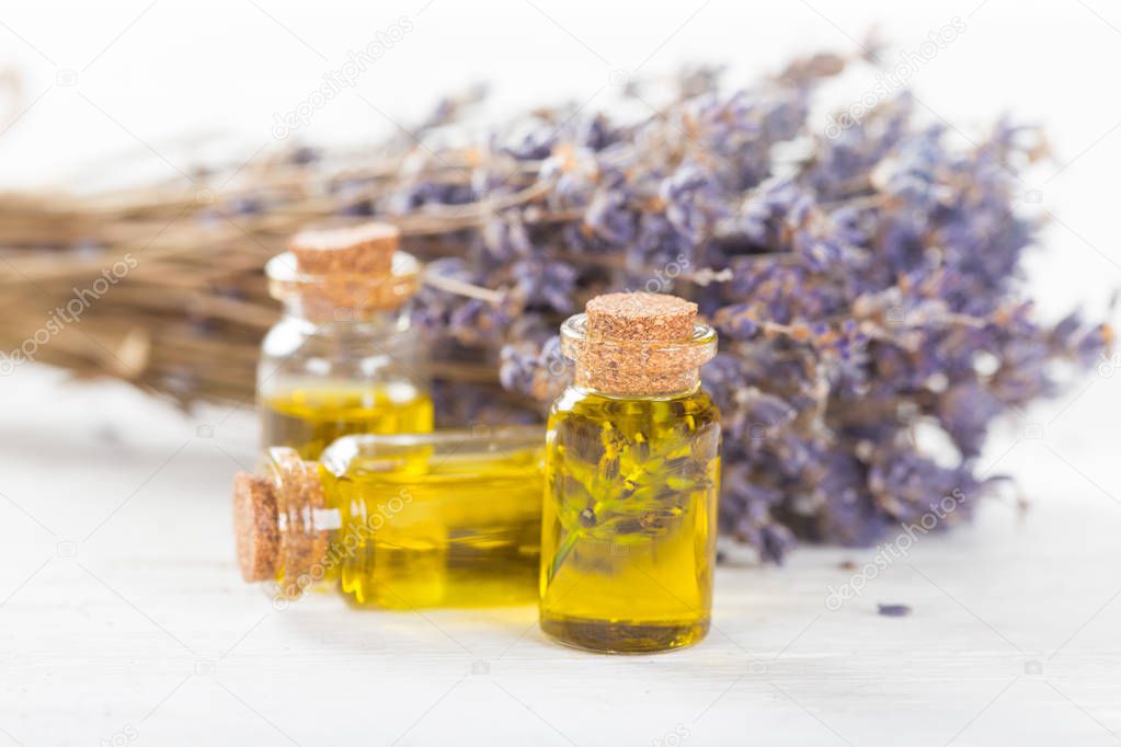 Wellness treatments with lavender flowers on wooden table.