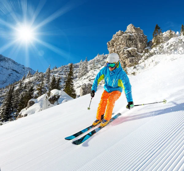 Skier skiing downhill in high mountains — Stock Photo, Image