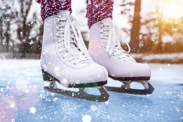 Close-up of woman ice skating on a pond.