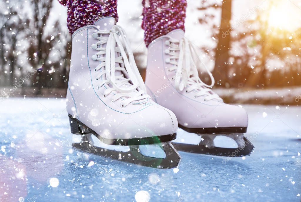 Close-up of woman ice skating on a pond.