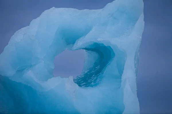 Icebergs swimming on frozen water, close-up. — Stock Photo, Image