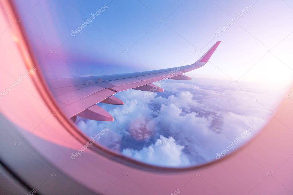 SuBeautiful sunset with cloudy sky from the airplane window.