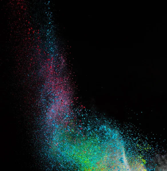 Lançado pó colorido, isolado em fundo preto — Fotografia de Stock