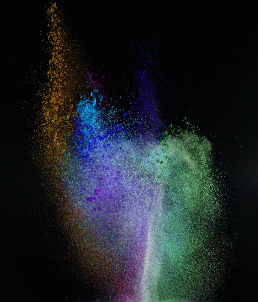 Launched colorful powder, isolated on black background — Stock Photo, Image