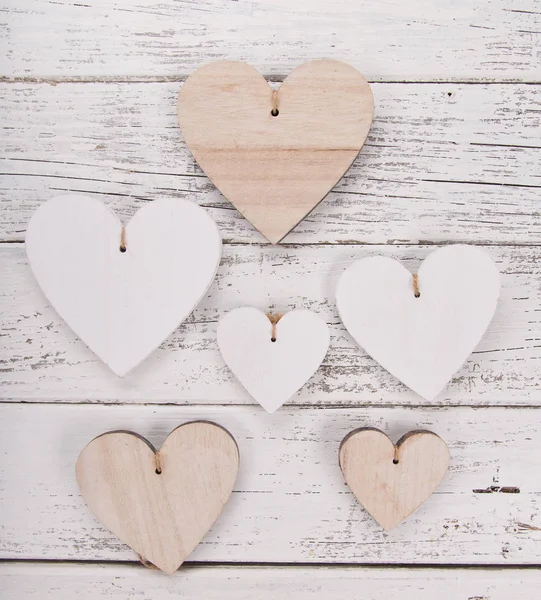 Heart composition for Valentines, Mothers or Womens Day. Wooden hearts on old white desk. — Stock Photo, Image