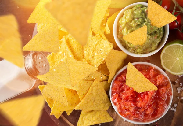 Tradition mexican guacamole and salsa dip, nachos tortilla chips.