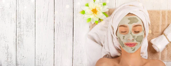 Young healthy woman with face clay mask. — Stock Photo, Image