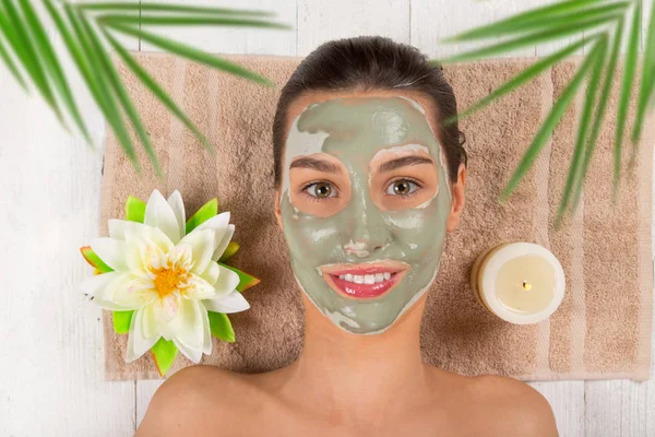 Young healthy woman with face clay mask. — Stock Photo, Image