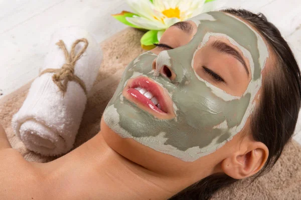 Young healthy woman with face clay mask. — Stock Photo, Image