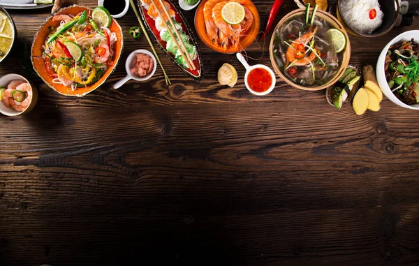 Verschillende van Aziatische maaltijden op rustieke achtergrond, bovenaanzicht, plaats voor tekst. — Stockfoto