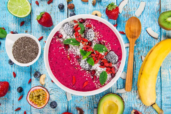Smoothie bowl with fresh berries, nuts, seeds, fruit and vegetables. — Stock Photo, Image