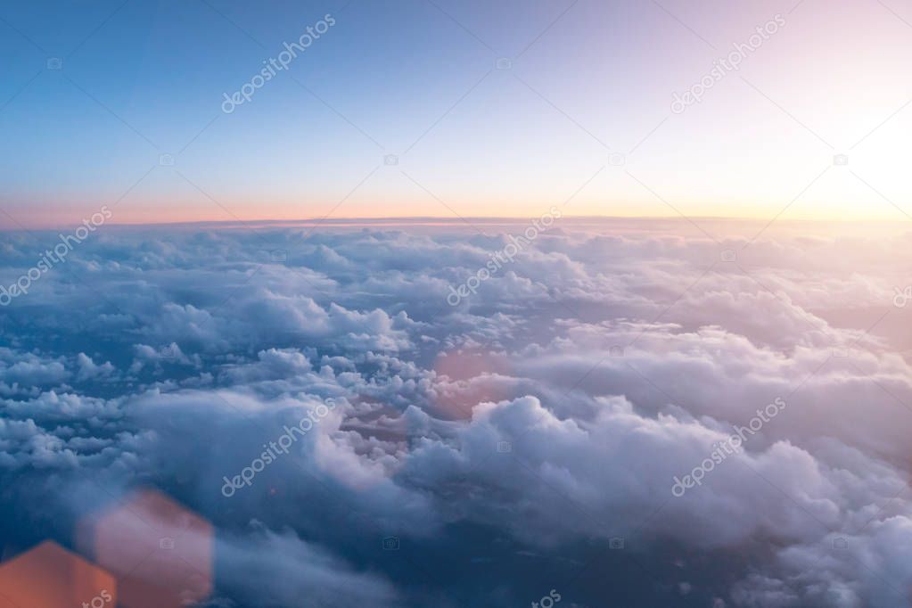 Beautiful sunset with cloudy sky from the airplane window.