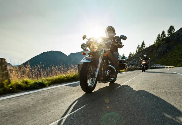 Motorcycle driver riding japanese high power cruiser in Alpine highway on famous Hochalpenstrasse, Austria. — Stock Photo, Image