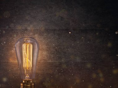 Vintage Edison light bulb on dark background. clipart