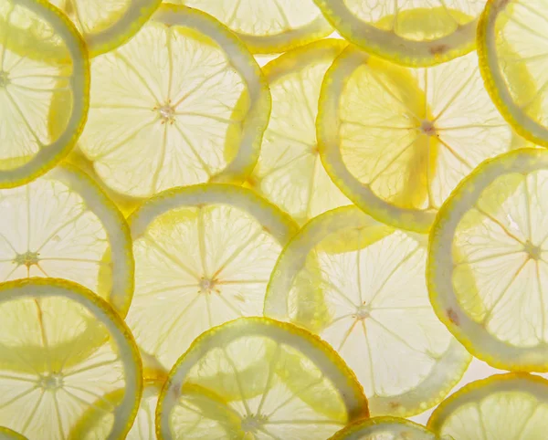 Brillantes rodajas de limón fresco, fruta transparente luz de fondo . —  Fotos de Stock