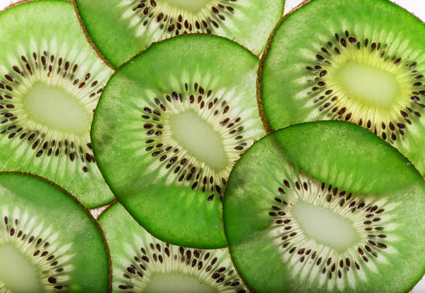 Bright fresh kiwi slices, back light transparent fruit. — Stock Photo, Image