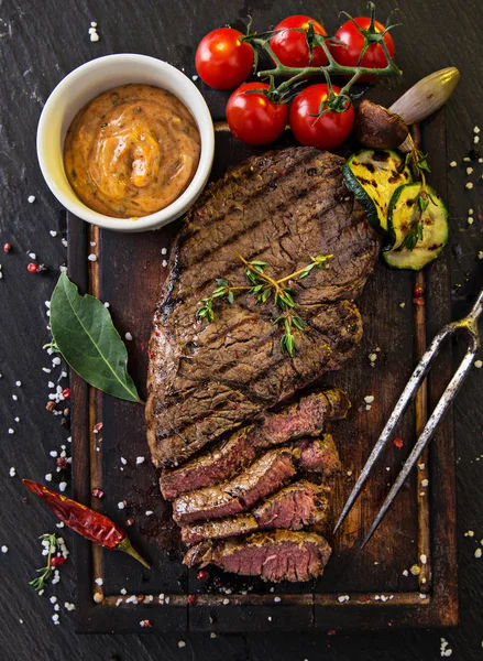 Delicious beef rump steak on wooden table — Stock Photo, Image