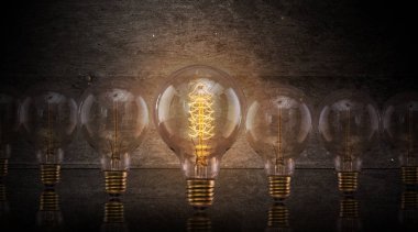 Vintage light bulbs on dark background. clipart