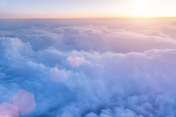 Beautiful sunset with cloudy sky from the airplane window. — Stock Photo, Image