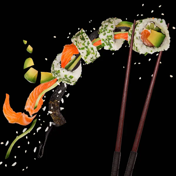 Pieces of delicious japanese sushi frozen in the air. — Stock Photo, Image