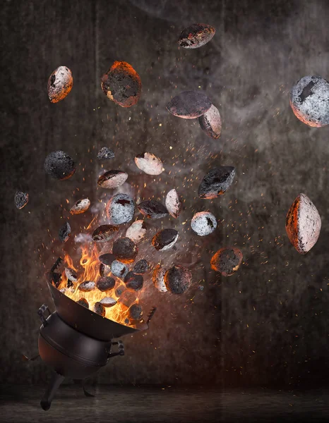 Kettle grill with hot briquettes flying in the air. — Stock Photo, Image