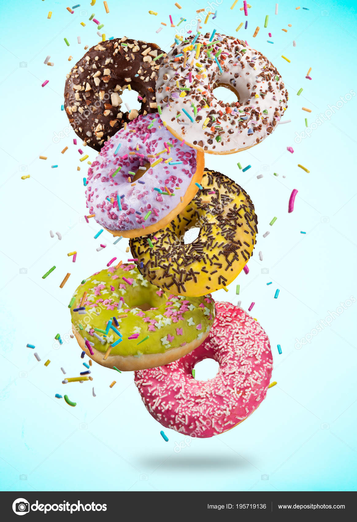 Tasty doughnuts in motion falling on pastel blue background. Stock