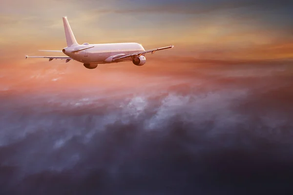 Commercial airplane flying above dramatic clouds. — Stock Photo, Image