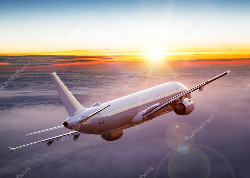 Commercial airplane flying above dramatic clouds.