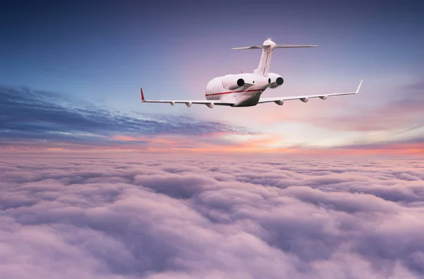 Privatjet fliegt über dramatischen Wolken. — Stockfoto