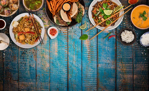 Fondo de comida asiática con varios ingredientes sobre fondo rústico de madera, vista superior. — Foto de Stock