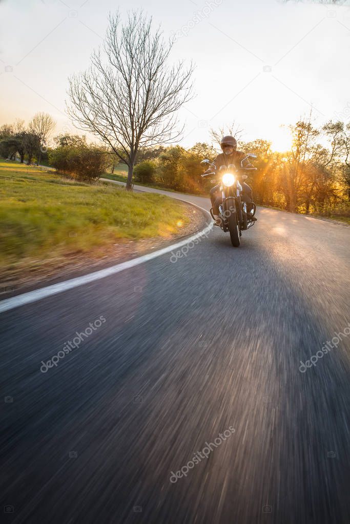 Motorcycle driver riding in Dolomite pass, Italy, Europe.