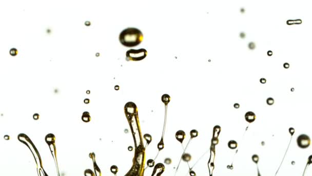 Super Slow Motion Shot of Splashing Oil on White Background at 1000 fps. — стоковое видео