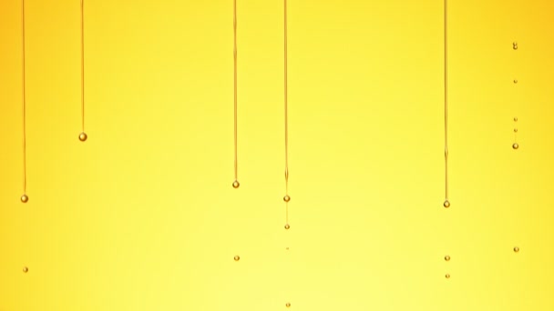 Super Slow Motion Shot of Dripping Oil on Golden Background. — Stock Video