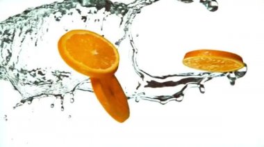 Fresh Fruit Slices Falling with Water Splash Cascade in Super Slow Motion