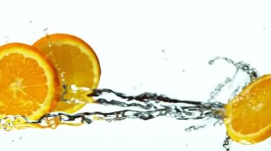 Fresh Fruit Slices Falling with Water Splash Cascade in Super Slow Motion