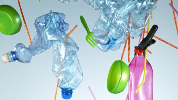 Super Slow Motion Shot of Flying Plastic Waste on Blue Gradient Background a 1000fps . — Vídeo de Stock