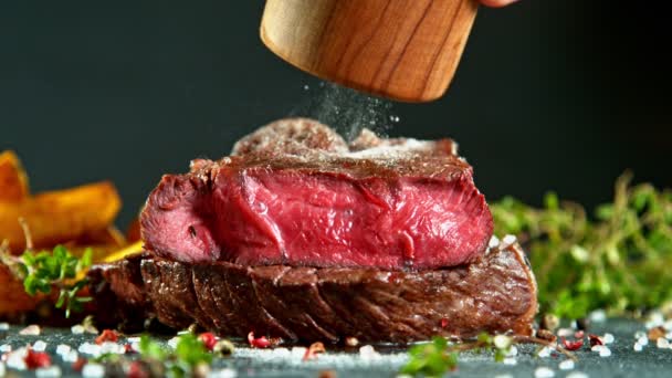 Detailní záběr padajícího chutného hovězího steaku, zpomalený film. — Stock video
