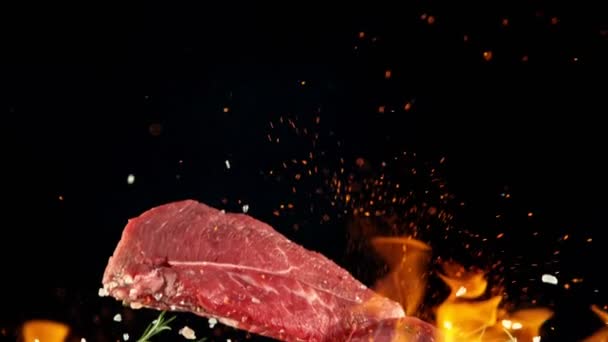 Close-up of falling tasty beef steak, slow motion. — Stok Video