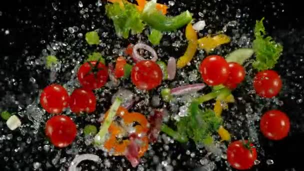 Fresh vegetables with water droplets exploding on black background. — Stock Video