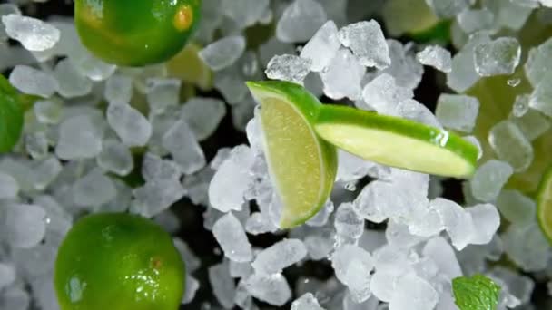 Super Slow Motion of exploding crushed ice with limes towards camera — Stock Video