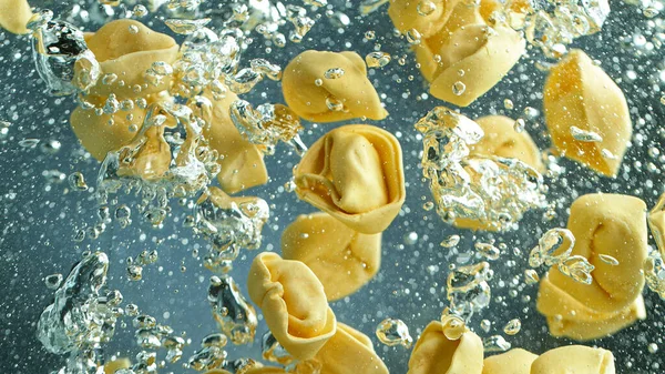 Throwing pasta into boiled water, slow motion. — Stock Photo, Image