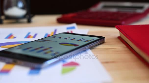 Mobile Phone, Pen, Laptop, Glasses And Paper With Stock Charts On Table. Modern Working Place. — Stock Video