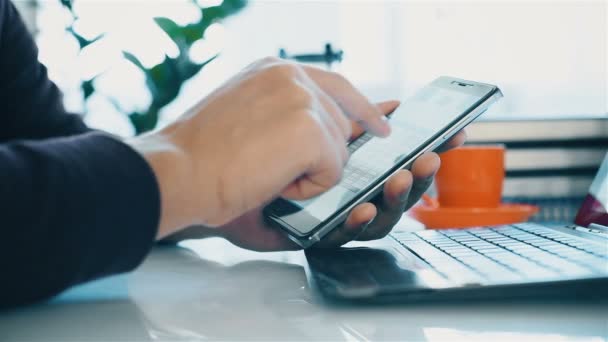 Businessman Using Phone With Stock Data And Typing on Laptop — Stock Video