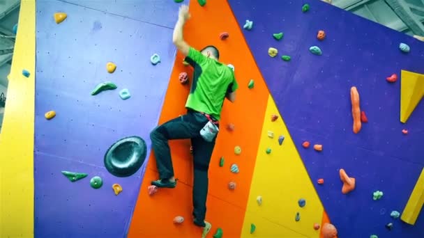 Man Climbing Up On Practice Wall Indoor — Stock Video