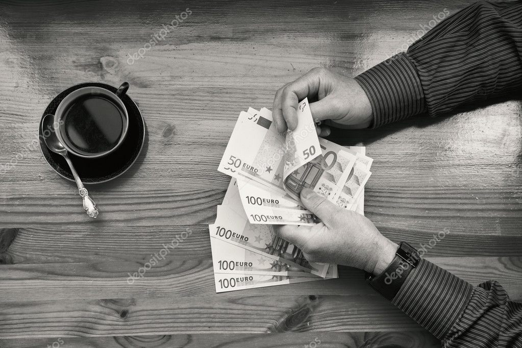 The rich man in shirt counting euro money and drinking coffee black and white photography a top view photo by devin pavel The rich man in shirt counting euro money and drinking coffee black and white photography a top view photo by devin pavel