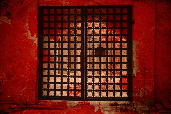 Fantastic gate. The gate to hell. Double exposure, beautiful big vintage metal gate and red texture vintage wall. Artistic creative processing — Stock Photo, Image